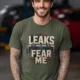 Leaks Fear Me T-Shirt - Funny Plumber Pipes Tee — military-green t-shirt, model photo | Pressure Tested Co