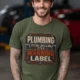 Plumbing Warning Label T-Shirt — Funny Plumber Shirt — military-green t-shirt, model photo | Pressure Tested Co