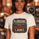 Plumbing Warning Label T-Shirt — Funny Plumber Shirt — natural t-shirt, model photo | Pressure Tested Co