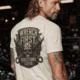Wrench First Tee — "Wrench First, Questions Later" Mechanic Skull T-Shirt — natural t-shirt, model photo | Pressure Tested Co