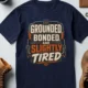 Grounded, Bonded and Slightly Tired Graphic Tee — Funny Electrical Worker Shirt — navy t-shirt, flat-lay product photo | Pressure Tested Co
