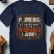 Plumbing Warning Label T-Shirt — Funny Plumber Shirt — navy t-shirt, flat-lay product photo | Pressure Tested Co