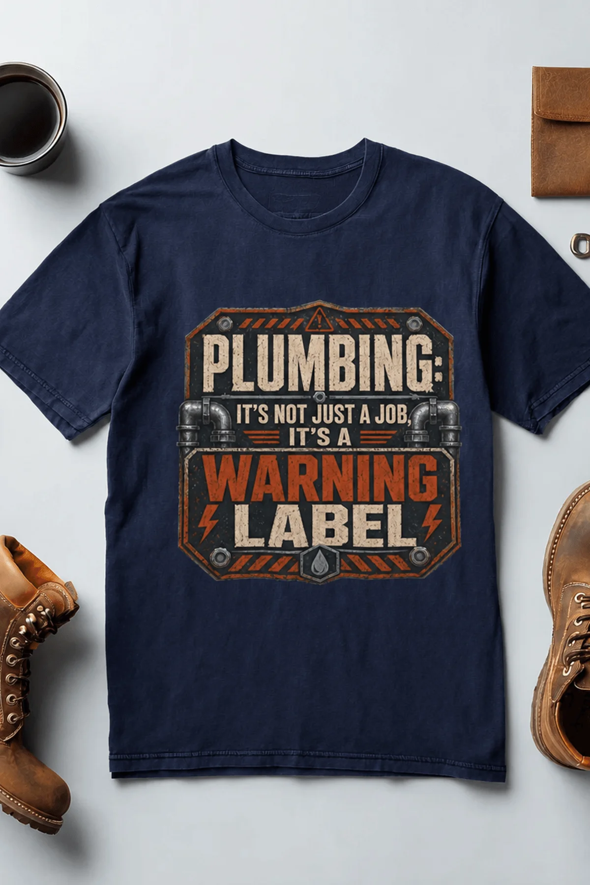 Plumbing Warning Label T-Shirt — Funny Plumber Shirt — navy t-shirt, flat-lay product photo | Pressure Tested Co