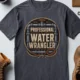 Funny Plumber Tee - "Professional Water Wrangler" Rustic Rope Graphic T-Shirt — navy t-shirt, flat-lay product photo | Pressure Tested Co