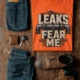 Leaks Fear Me T-Shirt - Funny Plumber Pipes Tee — orange t-shirt, flat-lay product photo | Pressure Tested Co