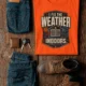 Funny HVAC Technician Tee - “I Fix The Weather Indoors.” Cooling/Furnace Shop Work Shirt — orange — Flat-lay Funny HVAC Technician Tee - “I Fix The Weather Indoors.” Cooling/Furnace Shop Work Shirt — orange t-shirt, flat-lay product photo | Pressure Tested Co
