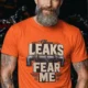 Leaks Fear Me T-Shirt - Funny Plumber Pipes Tee — orange t-shirt, model photo | Pressure Tested Co