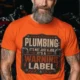 Plumbing Warning Label T-Shirt — Funny Plumber Shirt — orange t-shirt, model photo | Pressure Tested Co