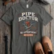 Plumber T-Shirt — "Pipe Doctor. No Appointment Needed" Vintage Work Shirt — pepper — Flat-lay Plumber T-Shirt — "Pipe Doctor. No Appointment Needed" Vintage Work Shirt — pepper t-shirt, flat-lay product photo | Pressure Tested Co