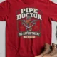 Plumber T-Shirt — "Pipe Doctor. No Appointment Needed" Vintage Work Shirt — red — Flat-lay Plumber T-Shirt — "Pipe Doctor. No Appointment Needed" Vintage Work Shirt — red t-shirt, flat-lay product photo | Pressure Tested Co