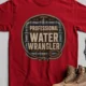 Funny Plumber Tee - "Professional Water Wrangler" Rustic Rope Graphic T-Shirt — red t-shirt, flat-lay product photo | Pressure Tested Co
