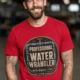 Funny Plumber Tee - "Professional Water Wrangler" Rustic Rope Graphic T-Shirt — red t-shirt, model photo | Pressure Tested Co