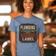Plumbing Warning Label T-Shirt — Funny Plumber Shirt — steel-blue t-shirt, model photo | Pressure Tested Co