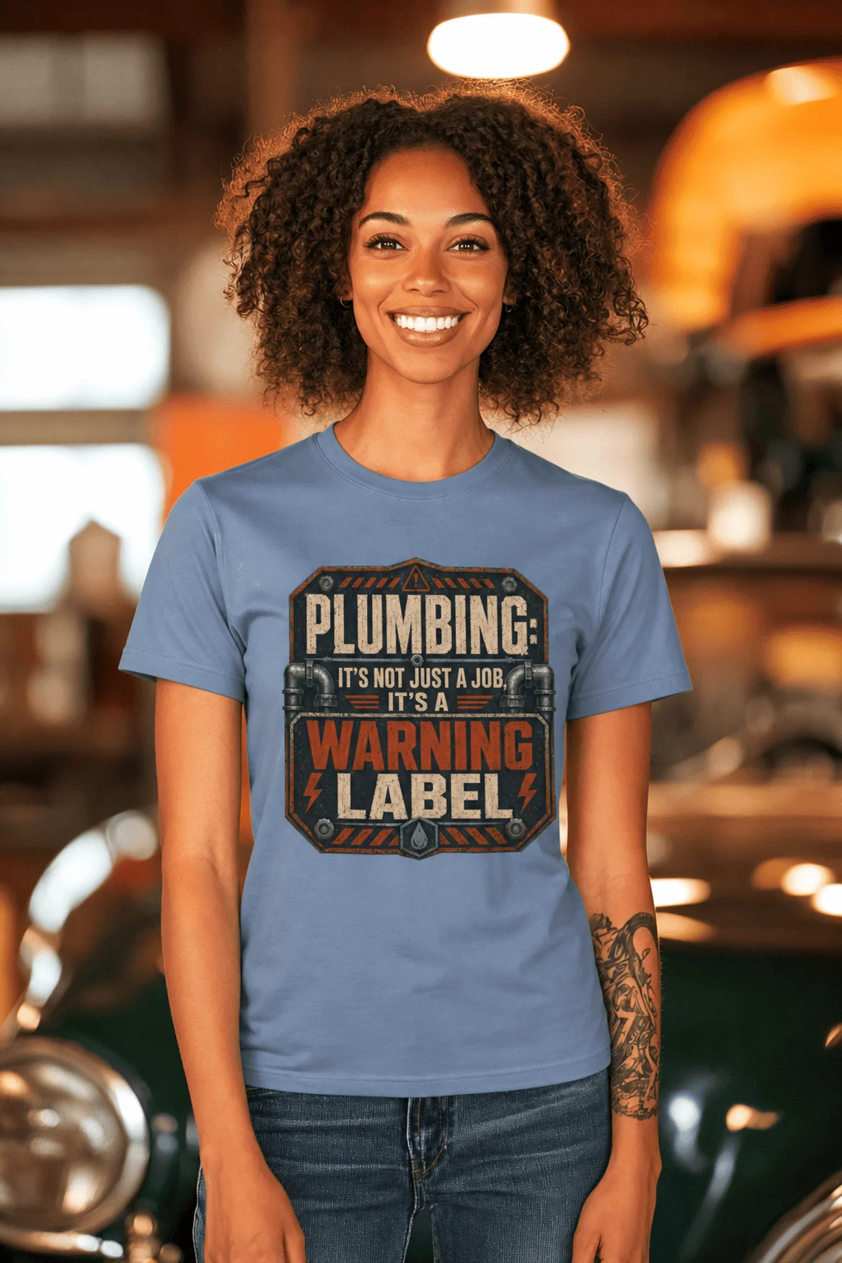 Plumbing Warning Label T-Shirt — Funny Plumber Shirt — steel-blue t-shirt, model photo | Pressure Tested Co