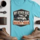 Bucket Truck T-Shirt - “My Other Ride Is A Bucket Truck” Utility Crew/Electrician Tee — turquoise t-shirt, flat-lay product photo | Pressure Tested Co