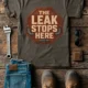 "The Leak Stops Here" Stop Sign Badge Style — Plumbing Repair Tech Humorous Tee — army t-shirt, flat-lay product photo | Pressure Tested Co