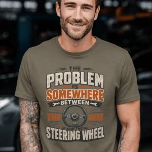 Driving Humor T-Shirt — "The Problem Is Somewhere Between The Seat And The Steering Wheel" — army t-shirt, model photo | Pressure Tested Co