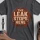 "The Leak Stops Here" Stop Sign Badge Style — Plumbing Repair Tech Humorous Tee — asphalt t-shirt, flat-lay product photo | Pressure Tested Co