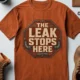 "The Leak Stops Here" Stop Sign Badge Style — Plumbing Repair Tech Humorous Tee — autumn t-shirt, flat-lay product photo | Pressure Tested Co