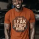 "The Leak Stops Here" Stop Sign Badge Style — Plumbing Repair Tech Humorous Tee — autumn t-shirt, model photo | Pressure Tested Co