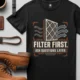 T-Shirt — "Filter First. Ask Questions Later." HVAC Air Filter Graphic — black t-shirt, flat-lay product photo | Pressure Tested Co