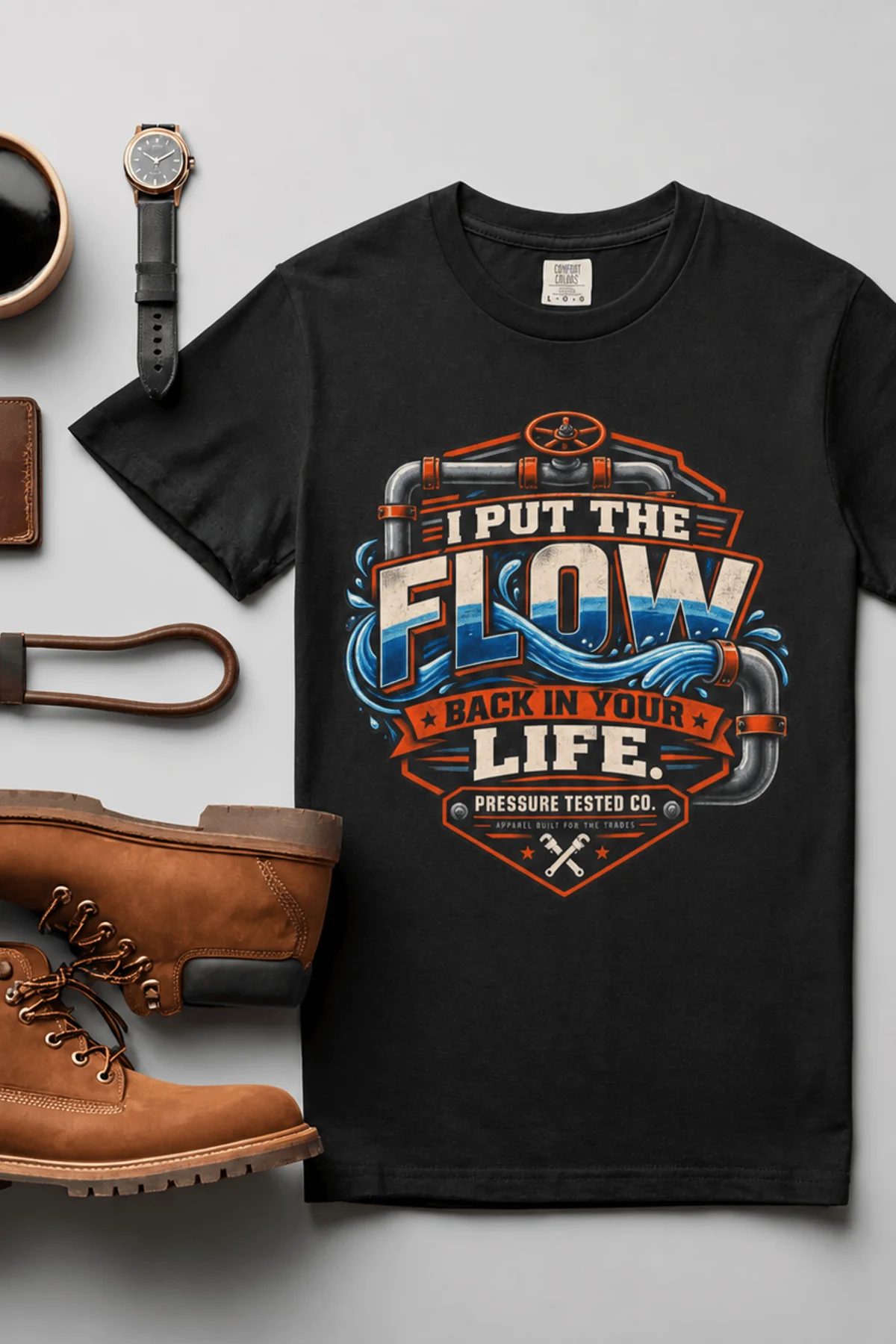 'I Put The Flow Back Into Your Life.' T-Shirt — Funny Retro Industrial Plumber's Tee — black t-shirt, flat-lay product photo | Pressure Tested Co