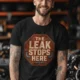 "The Leak Stops Here" Stop Sign Badge Style — Plumbing Repair Tech Humorous Tee — black t-shirt, model photo | Pressure Tested Co