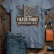T-Shirt — "Filter First. Ask Questions Later." HVAC Air Filter Graphic — blue-jean t-shirt, flat-lay product photo | Pressure Tested Co