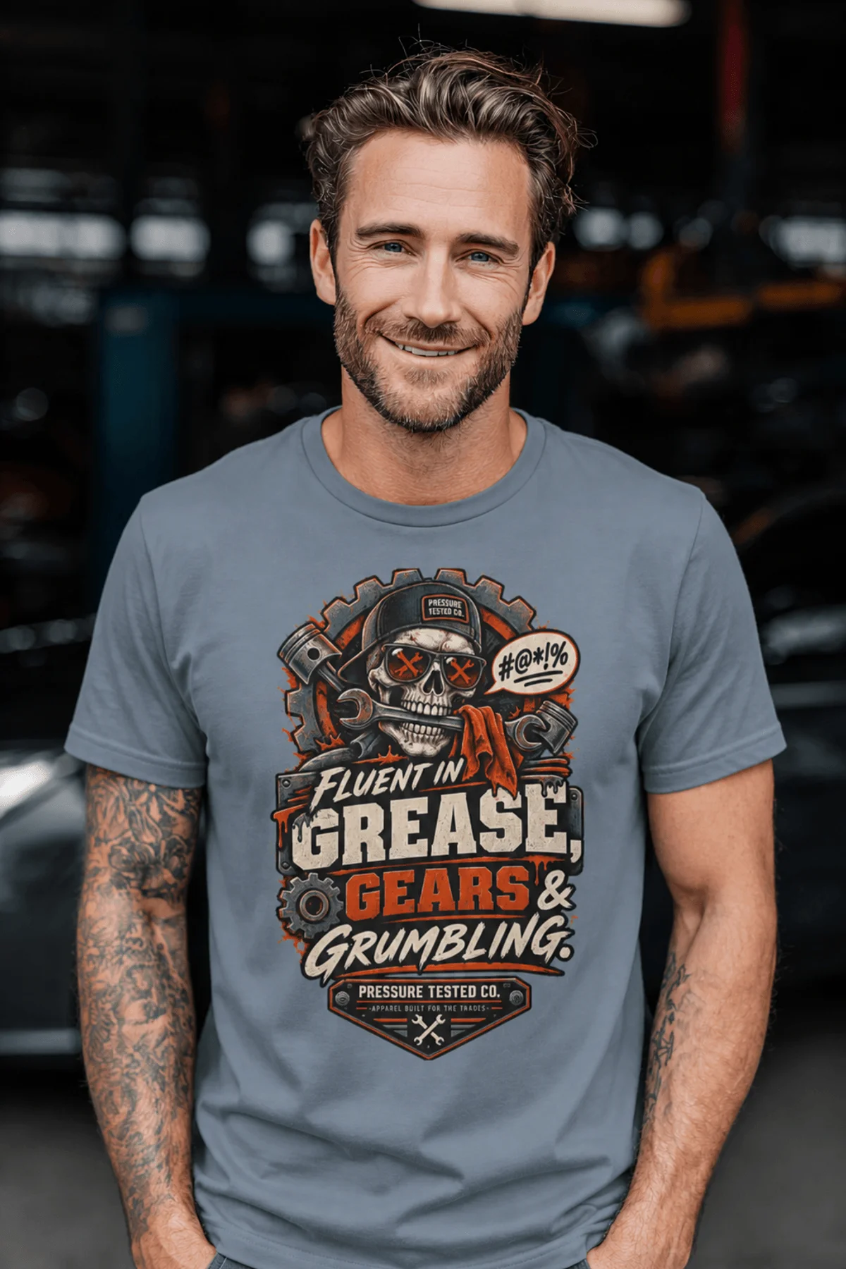 Mechanic Skull T-Shirt — "Fluent in Grease, Gears and Grumbling" Graphic Tee — blue-jean t-shirt, model photo | Pressure Tested Co