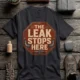 "The Leak Stops Here" Stop Sign Badge Style — Plumbing Repair Tech Humorous Tee — dark-grey t-shirt, flat-lay product photo | Pressure Tested Co