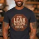 "The Leak Stops Here" Stop Sign Badge Style — Plumbing Repair Tech Humorous Tee — dark-grey t-shirt, model photo | Pressure Tested Co
