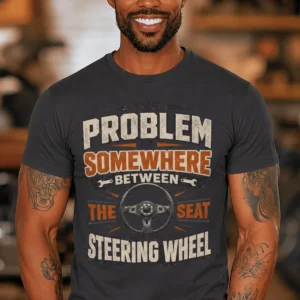 Driving Humor T-Shirt — "The Problem Is Somewhere Between The Seat And The Steering Wheel" — dark-grey t-shirt, model photo | Pressure Tested Co