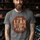 "The Leak Stops Here" Stop Sign Badge Style — Plumbing Repair Tech Humorous Tee — deep-heather t-shirt, model photo | Pressure Tested Co