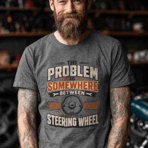Driving Humor T-Shirt — "The Problem Is Somewhere Between The Seat And The Steering Wheel" — deep-heather t-shirt, model photo | Pressure Tested Co
