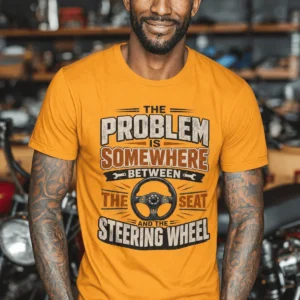 Driving Humor T-Shirt — "The Problem Is Somewhere Between The Seat And The Steering Wheel" — gold t-shirt, model photo | Pressure Tested Co