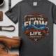 'I Put The Flow Back Into Your Life.' T-Shirt — Funny Retro Industrial Plumber's Tee — graphite t-shirt, flat-lay product photo | Pressure Tested Co