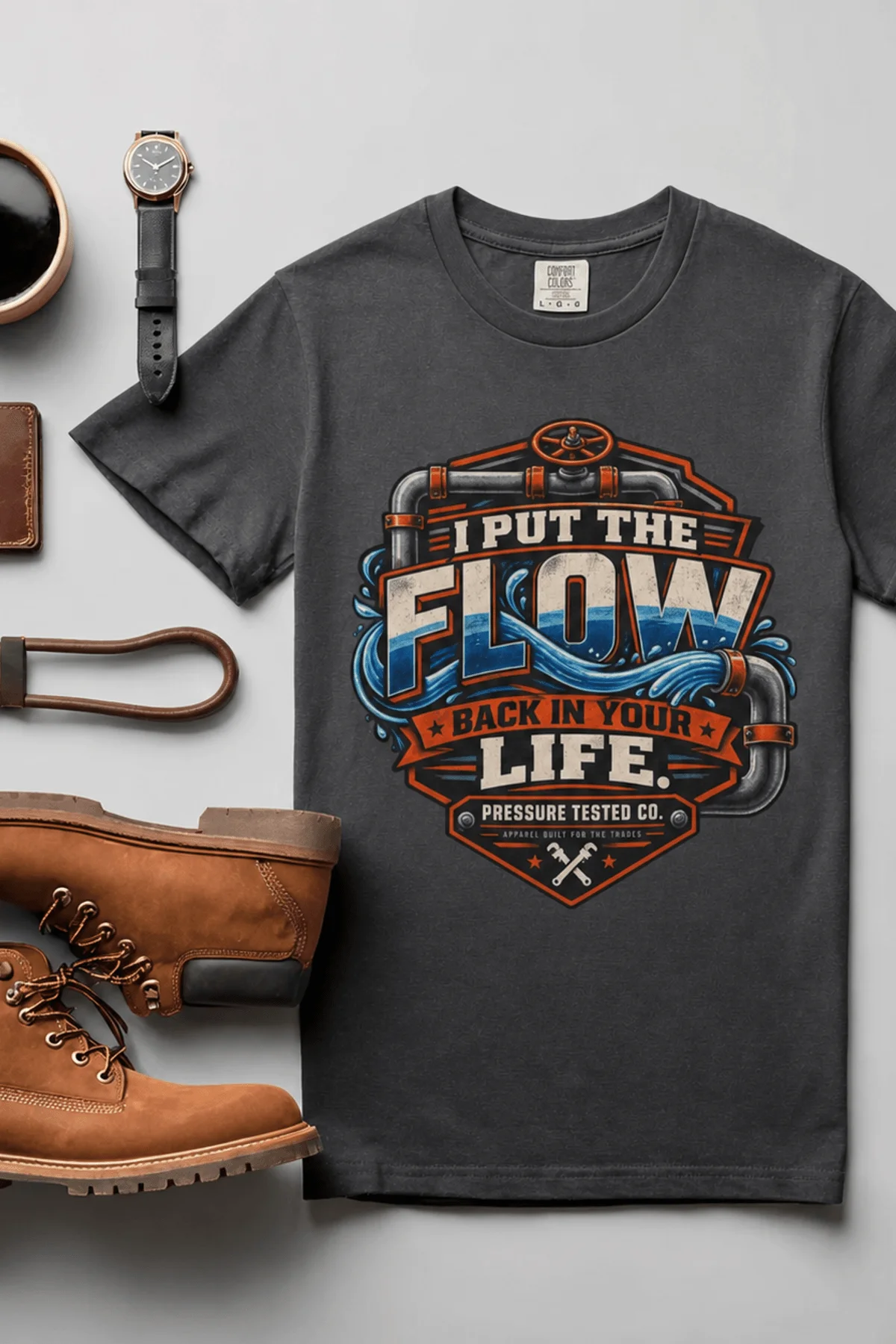 'I Put The Flow Back Into Your Life.' T-Shirt — Funny Retro Industrial Plumber's Tee — graphite t-shirt, flat-lay product photo | Pressure Tested Co