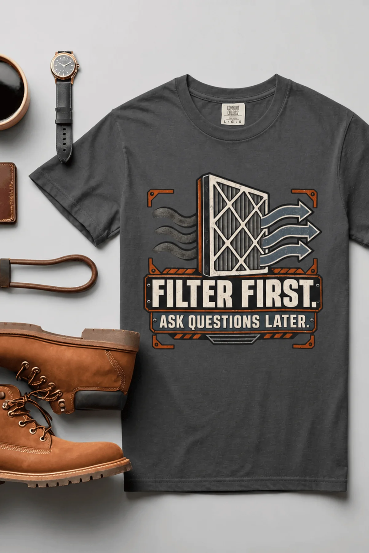 T-Shirt — "Filter First. Ask Questions Later." HVAC Air Filter Graphic — graphite t-shirt, flat-lay product photo | Pressure Tested Co