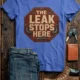 "The Leak Stops Here" Stop Sign Badge Style — Plumbing Repair Tech Humorous Tee — heather-columbia-blue t-shirt, flat-lay product photo | Pressure Tested Co