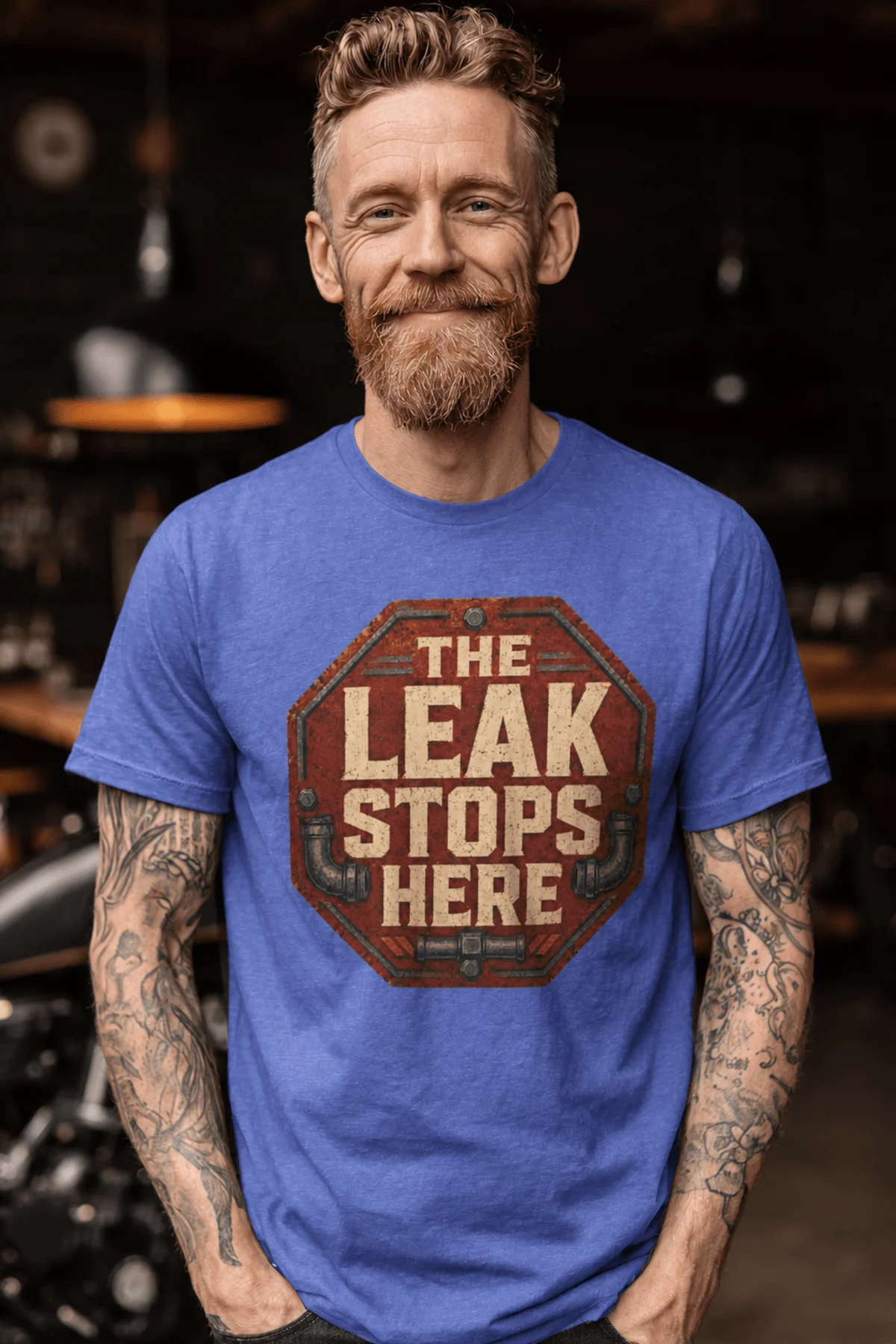 "The Leak Stops Here" Stop Sign Badge Style — Plumbing Repair Tech Humorous Tee — heather-columbia-blue t-shirt, model photo | Pressure Tested Co