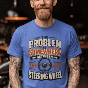 Driving Humor T-Shirt — "The Problem Is Somewhere Between The Seat And The Steering Wheel" — heather-columbia-blue t-shirt, model photo | Pressure Tested Co