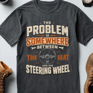 Driving Humor T-Shirt — "The Problem Is Somewhere Between The Seat And The Steering Wheel" — heather-navy t-shirt, flat-lay product photo | Pressure Tested Co