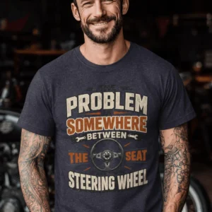 Driving Humor T-Shirt — "The Problem Is Somewhere Between The Seat And The Steering Wheel" — heather-navy t-shirt, model photo | Pressure Tested Co