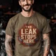 "The Leak Stops Here" Stop Sign Badge Style — Plumbing Repair Tech Humorous Tee — heather-olive t-shirt, model photo | Pressure Tested Co