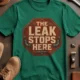 "The Leak Stops Here" Stop Sign Badge Style — Plumbing Repair Tech Humorous Tee — kelly t-shirt, flat-lay product photo | Pressure Tested Co