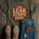 "The Leak Stops Here" Stop Sign Badge Style — Plumbing Repair Tech Humorous Tee — military-green t-shirt, flat-lay product photo | Pressure Tested Co