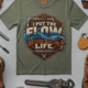 'I Put The Flow Back Into Your Life.' T-Shirt — Funny Retro Industrial Plumber's Tee — moss t-shirt, flat-lay product photo | Pressure Tested Co