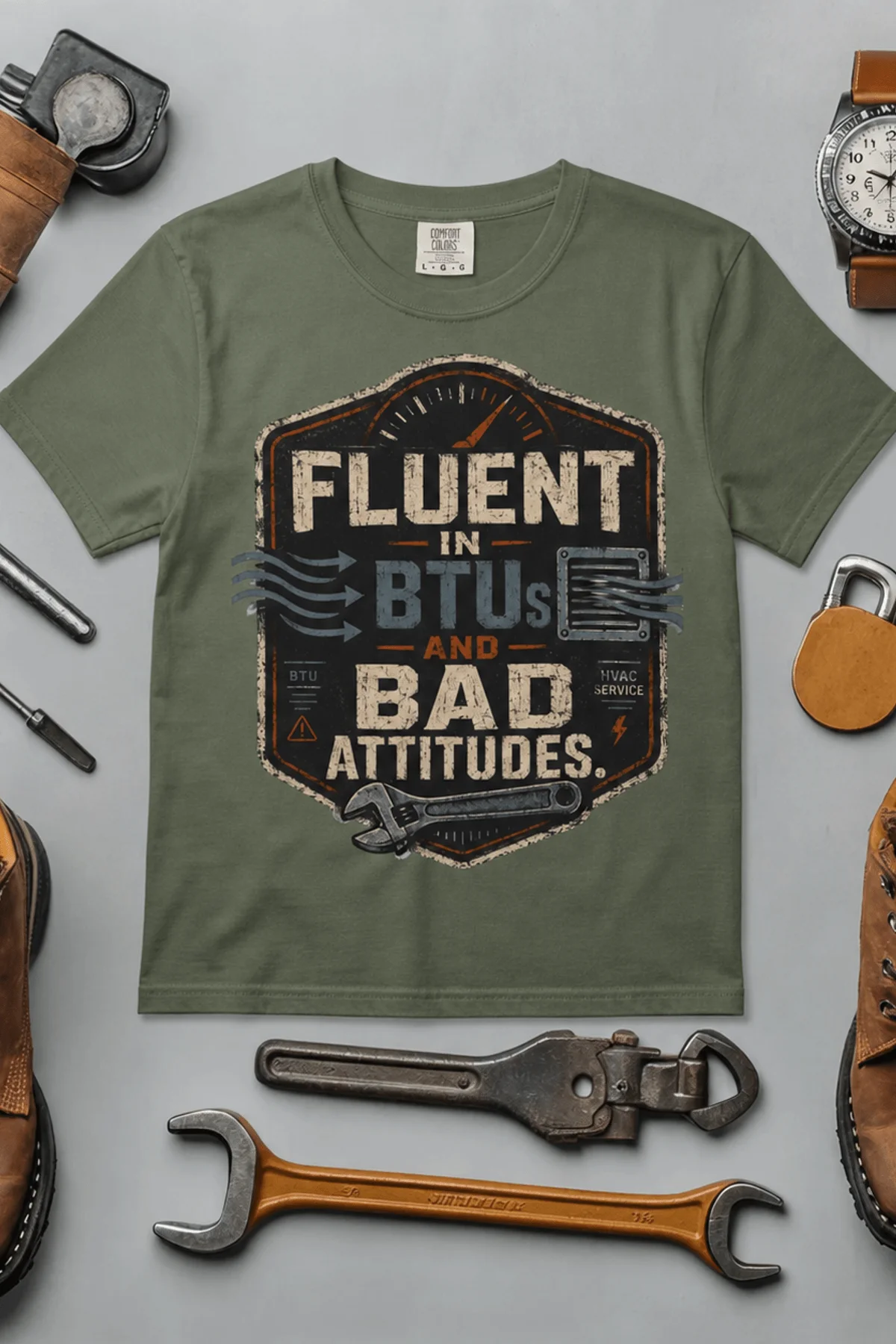 HVAC Tech T‑Shirt – "Fluent In BTUs And Bad Attitudes" — moss t-shirt, flat-lay product photo | Pressure Tested Co