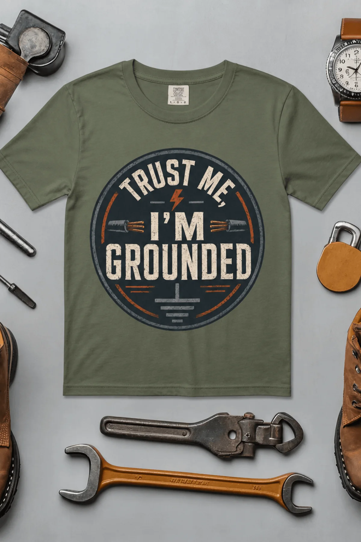 Grounded T‑Shirt – "Trust Me I'm Grounded" Electrical Tech Tee — moss t-shirt, flat-lay product photo | Pressure Tested Co