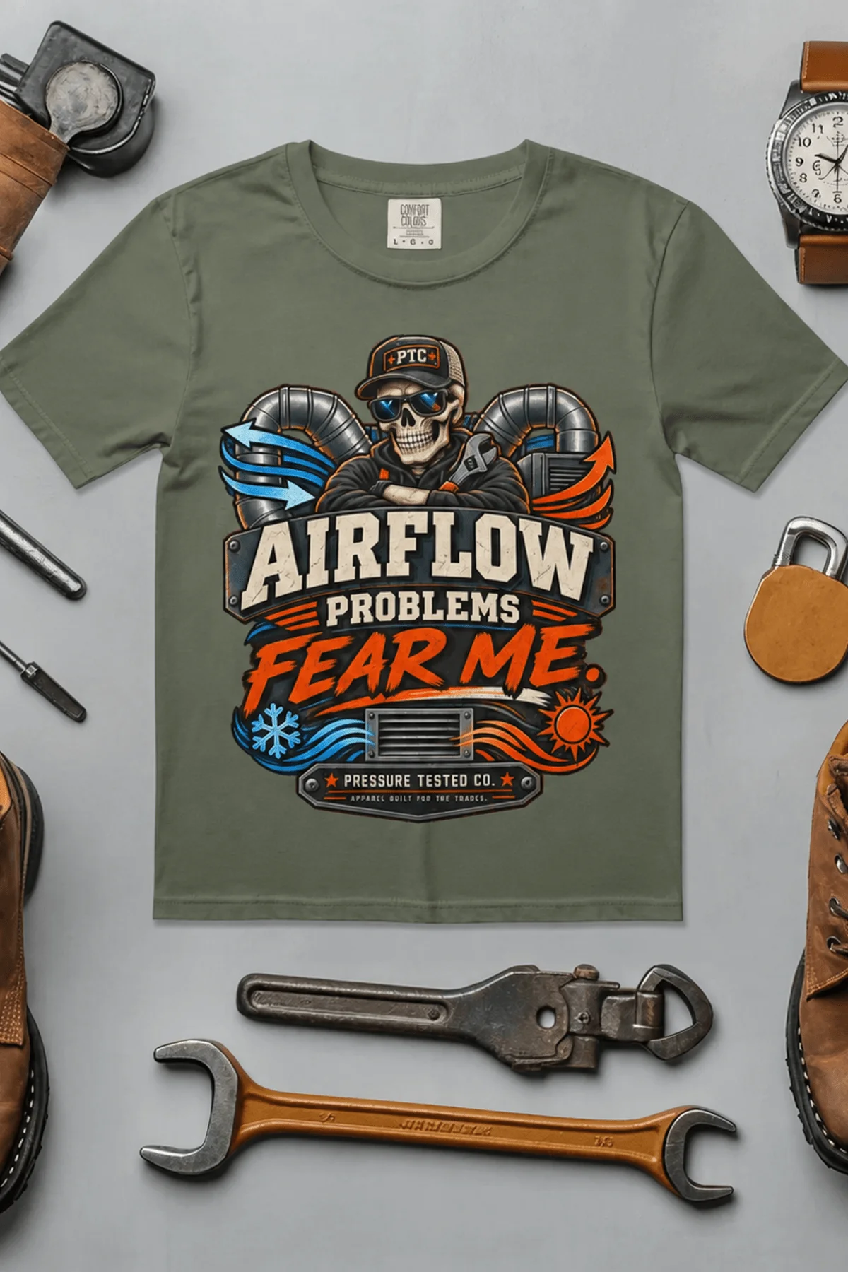 Airflow Problems Fear Me T-Shirt — HVAC Technician Skull Logo Tee — moss t-shirt, flat-lay product photo | Pressure Tested Co